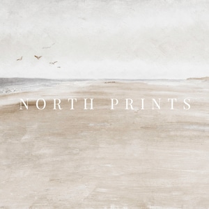 May include: A minimalist watercolour painting of a beach scene with a light grey sky, a light blue ocean, and a sandy beach. The text "NORTH PRINTS" is printed in white at the bottom of the image.