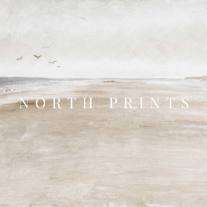 May include: A minimalist watercolour painting of a beach scene with a light grey sky, a light blue ocean, and a sandy beach. The text "NORTH PRINTS" is printed in white at the bottom of the image.