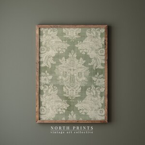 May include: A framed print of a vintage green and white damask pattern. The print is in a wooden frame and has a distressed look. The text "NORTH PRINTS vintage art collective" is at the bottom of the image.