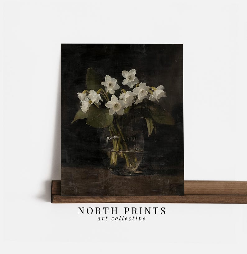 May include: A bouquet of white flowers in a clear glass vase on a dark brown wooden surface. The flowers are arranged in a simple, elegant style, and the vase is partially obscured by the flowers.