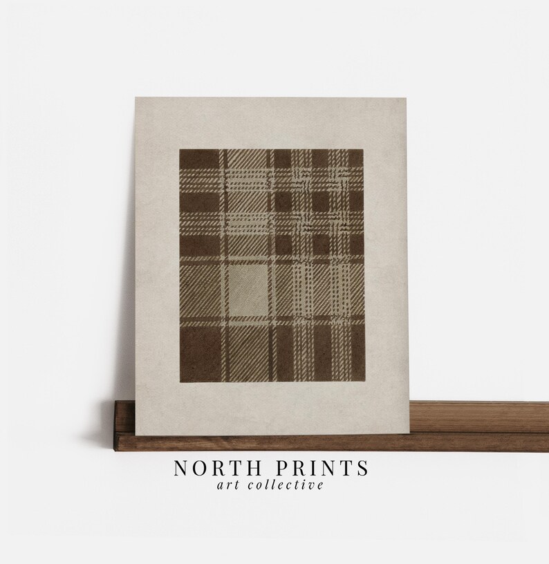 May include: A framed print featuring a brown plaid pattern on a beige background. The artwork has a vintage aesthetic, with the text "NORTH PRINTS art collective" printed at the bottom.