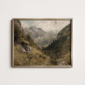 May include: A vintage painting depicting a mountain landscape with a valley in the foreground. The painting is framed in a gold frame and has a muted color palette of browns, greens, and grays.