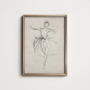 May include: A black and white line drawing of a ballerina in a flowing skirt, framed in a gold frame.