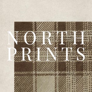May include: A close-up of a section of a brown and beige plaid pattern fabric. The text "NORTH PRINTS" is overlaid in white, with the letters stacked vertically. The background is a solid beige color.