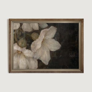 May include: A framed painting of white flowers with a dark background. The flowers are in focus and the background is blurred.