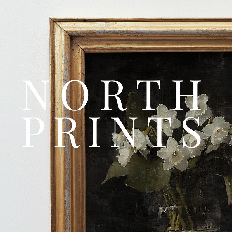 May include: A framed print of a still life featuring white flowers in a glass vase. The print is in a gold frame with a distressed finish. The text "NORTH PRINTS" is visible in the image.