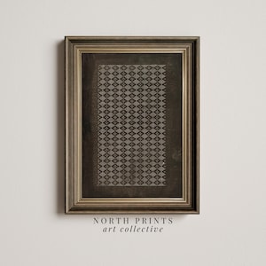 May include: A framed print with a geometric pattern in shades of brown and white. The print is in a simple, modern style and is perfect for adding a touch of sophistication to any room. The frame is a dark brown wood with a gold trim.