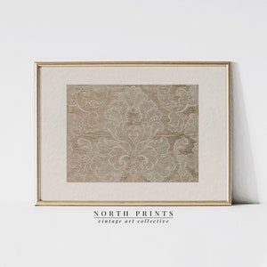 May include: A framed print of a vintage damask pattern in shades of brown and white. The print is in a gold frame and has the text "NORTH PRINTS vintage art collective" below it.