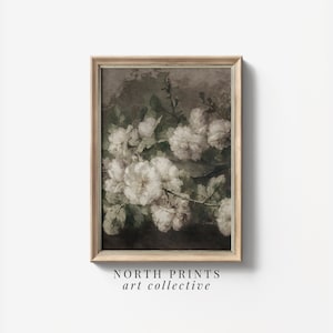 May include: A framed vintage botanical print featuring a cluster of white flowers with green leaves against a dark brown background. The print is in a light wood frame.