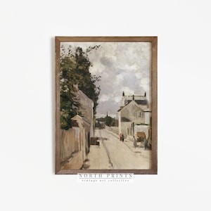 May include: A framed painting depicting a street scene in a small town. The painting features a narrow street lined with buildings, trees, and a cloudy sky. The buildings are painted in muted tones of gray and white, while the trees are a vibrant green. The sky is a soft blue with wispy clouds.