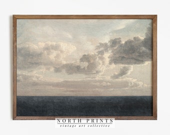 Puede incluir: Una pintura vintage enmarcada que representa un paisaje marítimo con un océano azul oscuro y un cielo nublado. El cielo es una mezcla de nubes grises claras y oscuras con un toque de rosa en la distancia.