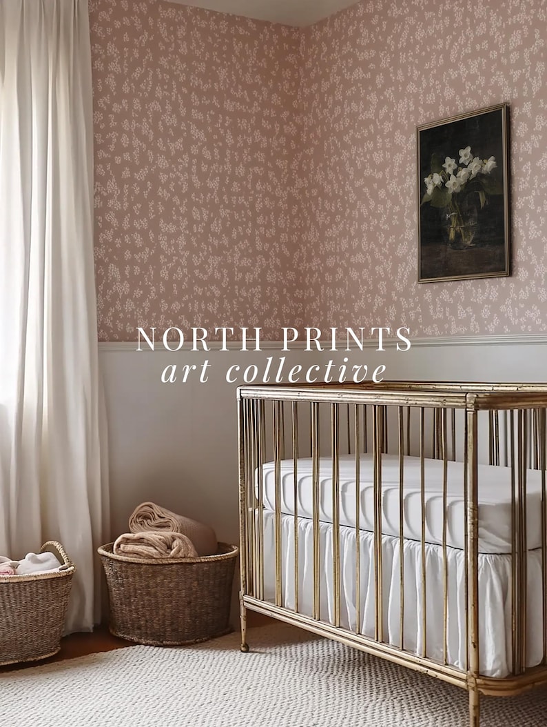 May include: A gold crib with a white mattress and a white ruffle. The crib is in a nursery with a pink floral wallpaper, a white curtain, and two wicker baskets.