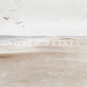 May include: A minimalist painting of a beach scene with a light blue sky, white clouds, and a sandy beach with waves. The text "NORTH PRINTS" is printed in white on the beach.