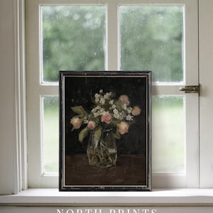 May include: A vintage framed painting of a bouquet of pink and white flowers in a glass vase. The flowers are arranged in a simple, elegant style, and the painting is set against a dark background.