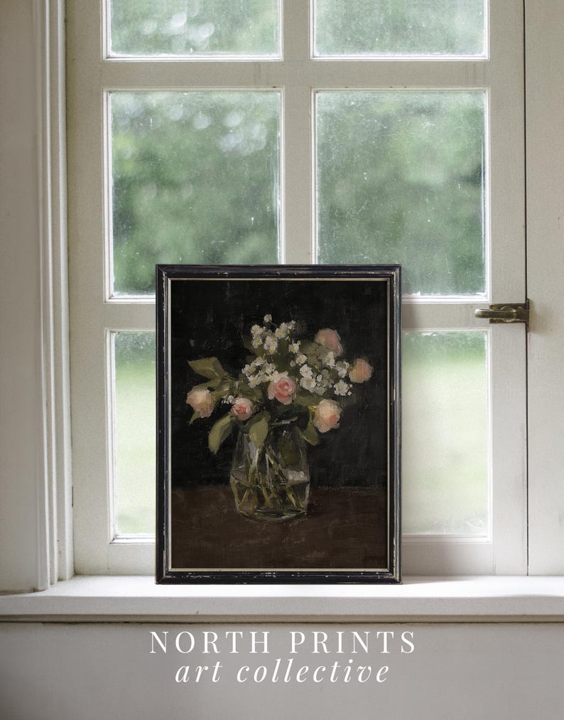 May include: A vintage framed painting of a bouquet of pink and white flowers in a glass vase. The flowers are arranged in a simple, elegant style, and the painting is set against a dark background.