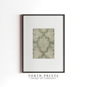 May include: A framed print of a vintage green and white damask pattern. The print is titled "NORTH PRINTS vintage art collective".