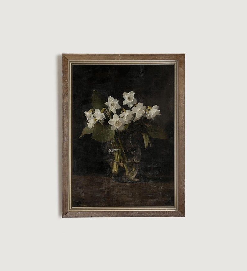 May include: A framed painting of a bouquet of white flowers in a glass vase. The flowers are arranged in a dark background, creating a dramatic and elegant composition.
