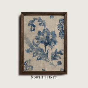 May include: A framed print featuring a blue floral design on a beige background. The artwork has a vintage aesthetic, with the floral pattern appearing to be hand-painted. The frame is a dark brown color, and the text "NORTH PRINTS" is at the bottom.