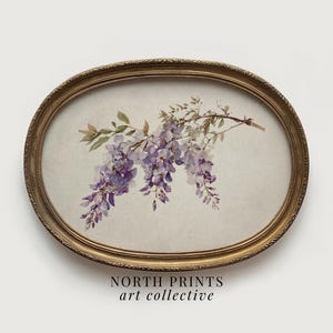 May include: An oval-shaped framed print featuring a watercolor illustration of wisteria flowers in shades of purple and green. The frame is gold-colored with an ornate design. The text "NORTH PRINTS art collective" is at the bottom.