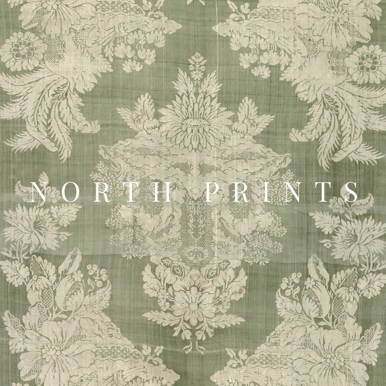 May include: A close-up of a green fabric with a white floral pattern. The fabric has a textured surface and a subtle sheen. The text "NORTH PRINTS" is printed in white on the fabric.