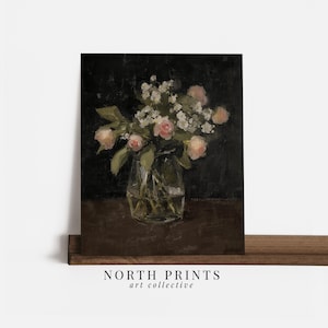 May include: A painting of a bouquet of pink roses and white flowers in a clear glass vase on a dark brown table.