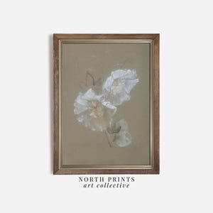 May include: A framed print of a botanical illustration featuring delicate white flowers with soft, pastel hues against a muted beige background. The print is in a simple, wooden frame.
