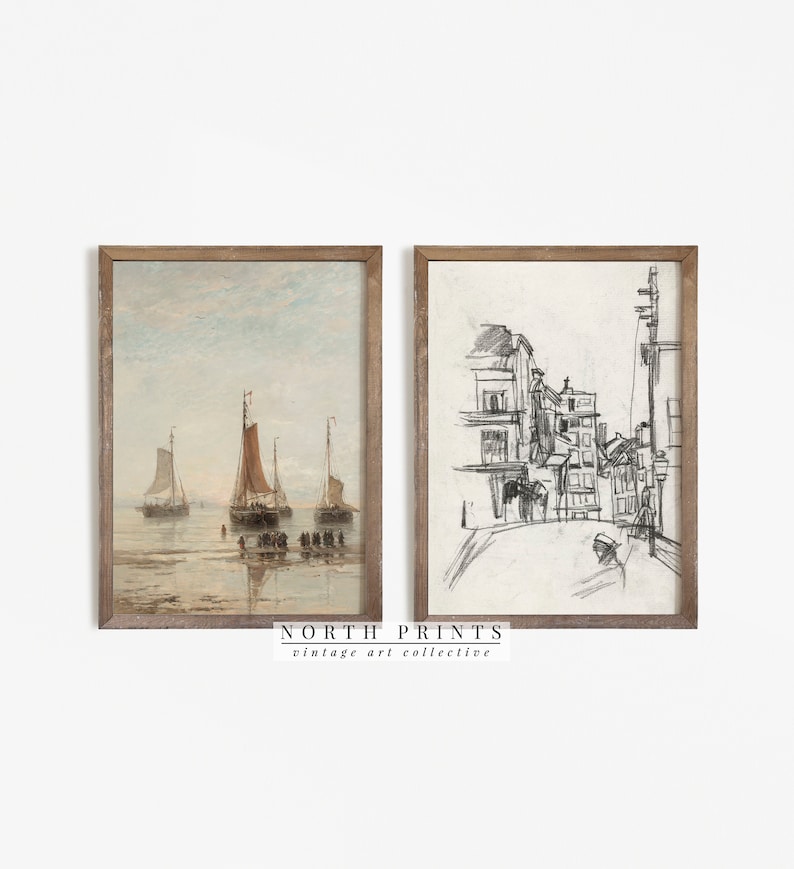 May include: Two framed vintage art prints. The left print is a watercolor of sailboats on the water with a light blue sky. The right print is a pencil sketch of a street scene. The frames are a light brown color. The text "NORTH PRINTS vintage art collective" is at the bottom.
