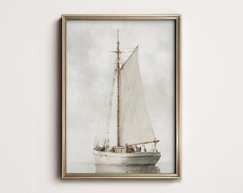 May include: A framed watercolor painting of a sailboat on calm water. The boat is white with a beige sail and a brown mast. The frame is gold. The background is a soft, muted gray.