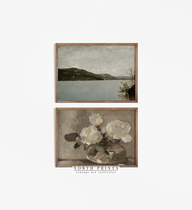 May include: Two framed vintage art prints. The top print depicts a landscape with a lake and mountains under a cloudy sky. The bottom print shows white roses in a glass vase. The text "NORTH PRINTS vintage art collective" is at the bottom.