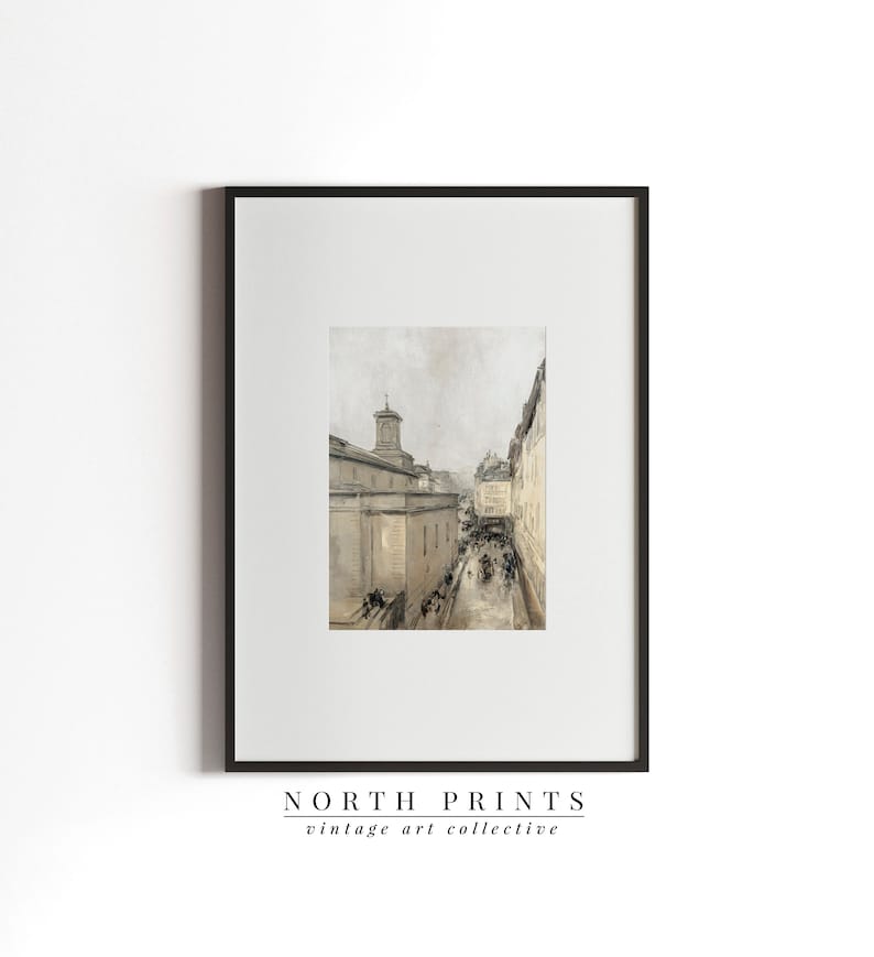 May include: A vintage black and white photograph of a street scene in a European city. The photo shows a narrow street with buildings on either side. The buildings are tall and have many windows. There are people walking on the street, and some are riding in horse-drawn carriages. The photo is framed in a black frame.