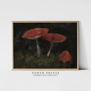 May include: A vintage painting of three red mushrooms with white stems growing in a dark forest setting. The painting is framed in a dark wood frame.