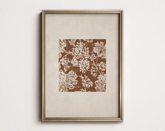 May include: A framed print featuring a floral pattern in shades of brown and white. The artwork is enclosed in a gold-colored frame, creating a classic and elegant aesthetic. The floral design is detailed and intricate, adding visual interest.