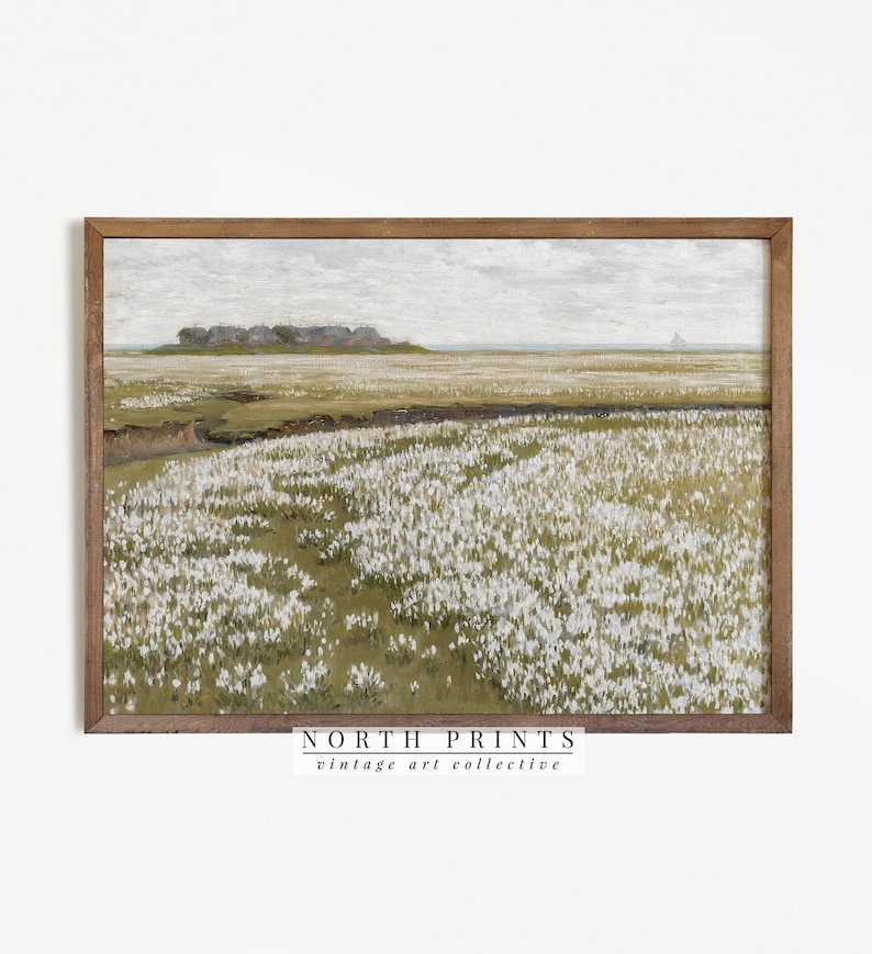 May include: A vintage painting of a field of white flowers with a distant view of a coastline and a small sailboat. The painting is framed in a brown wood frame and has the text "NORTH PRINTS vintage art collective" at the bottom.