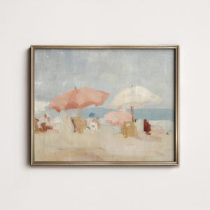 Puede incluir: Impresi&oacute;n art&iacute;stica enmarcada de una escena de playa. La pintura representa una playa de arena con sombrillas rosas y blancas. El mar es visible en el fondo, bajo un cielo azul claro. La obra de arte est&aacute; en un marco dorado.