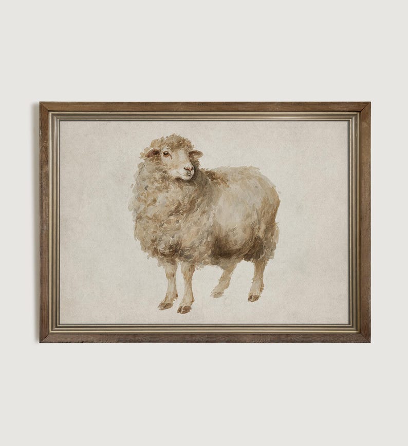 May include: Watercolor painting of a sheep in a wooden frame. The sheep is depicted in shades of beige and brown, with a fluffy coat and a serene expression. The artwork is framed with a brown wooden frame, adding a rustic touch to the piece.
