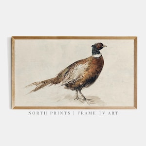 May include: A framed watercolor print of a pheasant. The bird is depicted in shades of brown, black, and white, with a detailed rendering of its feathers. The artwork is set against a neutral background and framed in a light brown wooden frame. The text "NORTH PRINTS | FRAME TV ART" is at the bottom.