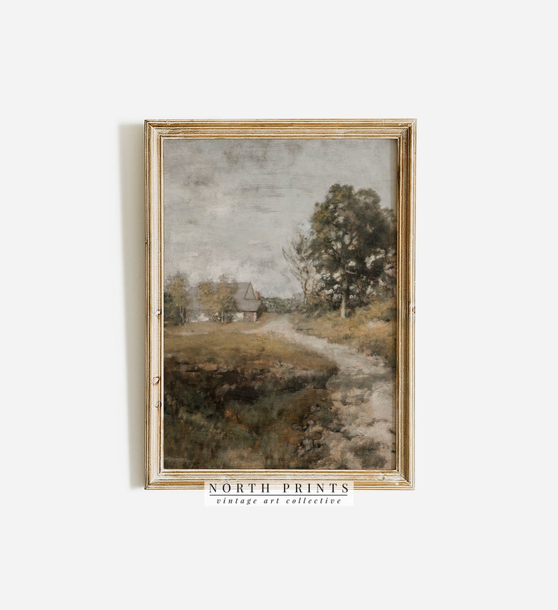 May include: A vintage painting in a gold frame depicts a rural landscape with a small house, trees, and a path leading into the distance. The sky is a muted gray with hints of blue, and the overall tone of the painting is soft and atmospheric.