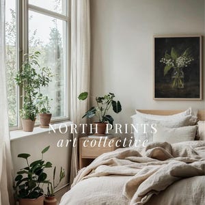 May include: A bedroom with a bed made with a white linen duvet cover and pillows. A framed botanical print of a bouquet of white flowers hangs on the wall above the bed. The text "NORTH PRINTS art collective" is visible in the image.