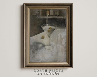 May include: A framed painting of a martini glass with olives on a white tablecloth. The painting is in a dark brown frame with a gold trim.