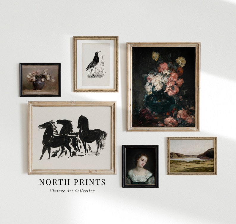 May include: A collection of framed art prints, including a black and white illustration of horses, a black and white illustration of a bird, a painting of flowers in a vase, a portrait of a woman, and a landscape painting. The prints are arranged on a white wall with the text "NORTH PRINTS Vintage Art Collective" below the prints.