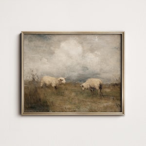 K&ouml;nnte beinhalten: Gerahmtes Gem&auml;lde im Vintage-Stil, das zwei Schafe auf einer Wiese unter einem bew&ouml;lkten Himmel zeigt. Das Kunstwerk verwendet ged&auml;mpfte T&ouml;ne von Braun, Beige und Grau mit einem goldfarbenen Rahmen. Die pastorale Szene vermittelt Ruhe.