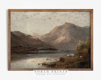 May include: A vintage landscape painting depicting a lake surrounded by mountains. The sky is a light blue with clouds, and the water is a calm, reflective blue. The mountains are a dark green and brown, and there are trees and bushes in the foreground. The painting is framed in a brown wooden frame.