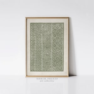 Può includere: Una stampa incorniciata con un motivo verde oliva su sfondo beige chiaro. Il design presenta bande verticali di forme geometriche e motivi floreali. La stampa è in una cornice dorata. Il testo "NORTH PRINTS art collective" è in basso.