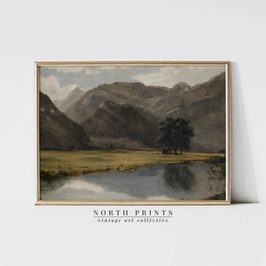 May include: A vintage painting depicting a tranquil lake nestled amongst rolling hills. The water is still, reflecting the sky and the surrounding landscape. The hills are covered in trees and foliage, creating a picturesque scene. The painting is framed in a gold frame.