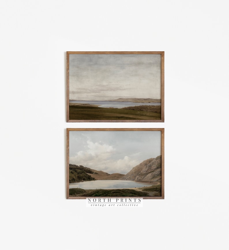 May include: Two framed landscape prints. The top print depicts a serene coastal scene with a muted color palette of greens, browns, and blues. The bottom print shows a lake surrounded by mountains. The frames are a warm brown color. The text "NORTH PRINTS vintage art collective" is at the bottom.