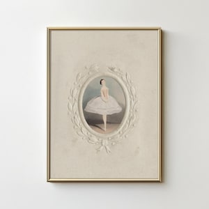 May include: A framed print of a ballerina in a white tutu, standing on one leg with her arms outstretched. The print is surrounded by a decorative, white, floral frame.