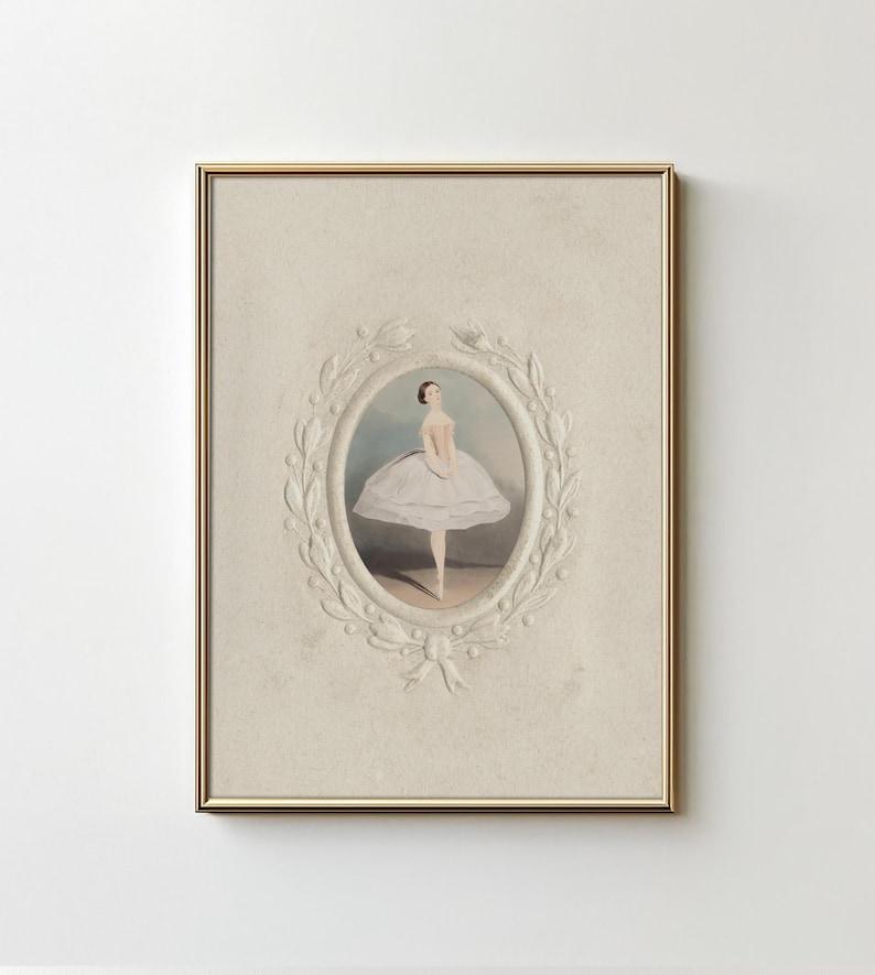 May include: A framed print of a ballerina in a white tutu, standing on one leg with her arms outstretched. The print is surrounded by a decorative, white, floral frame.