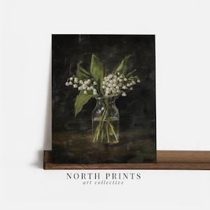 May include: A painting of a bouquet of white lily of the valley flowers in a clear glass vase on a dark background.