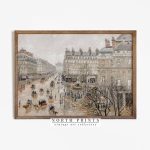 May include: A framed vintage art print showing a rainy street scene in a European city. The artwork features buildings, horse-drawn carriages, and people. The print has a neutral colour palette with a wooden frame. The text "NORTH PRINTS vintage art collective" is at the bottom.