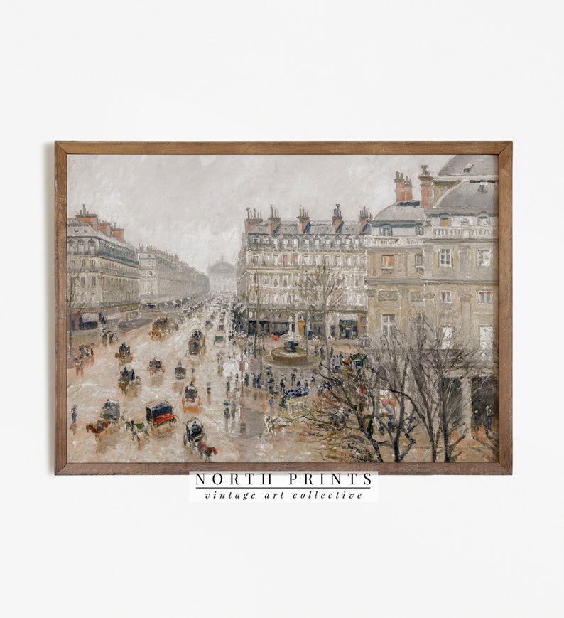 May include: A framed vintage art print showing a rainy street scene in a European city. The artwork features buildings, horse-drawn carriages, and people. The print has a neutral colour palette with a wooden frame. The text "NORTH PRINTS vintage art collective" is at the bottom.